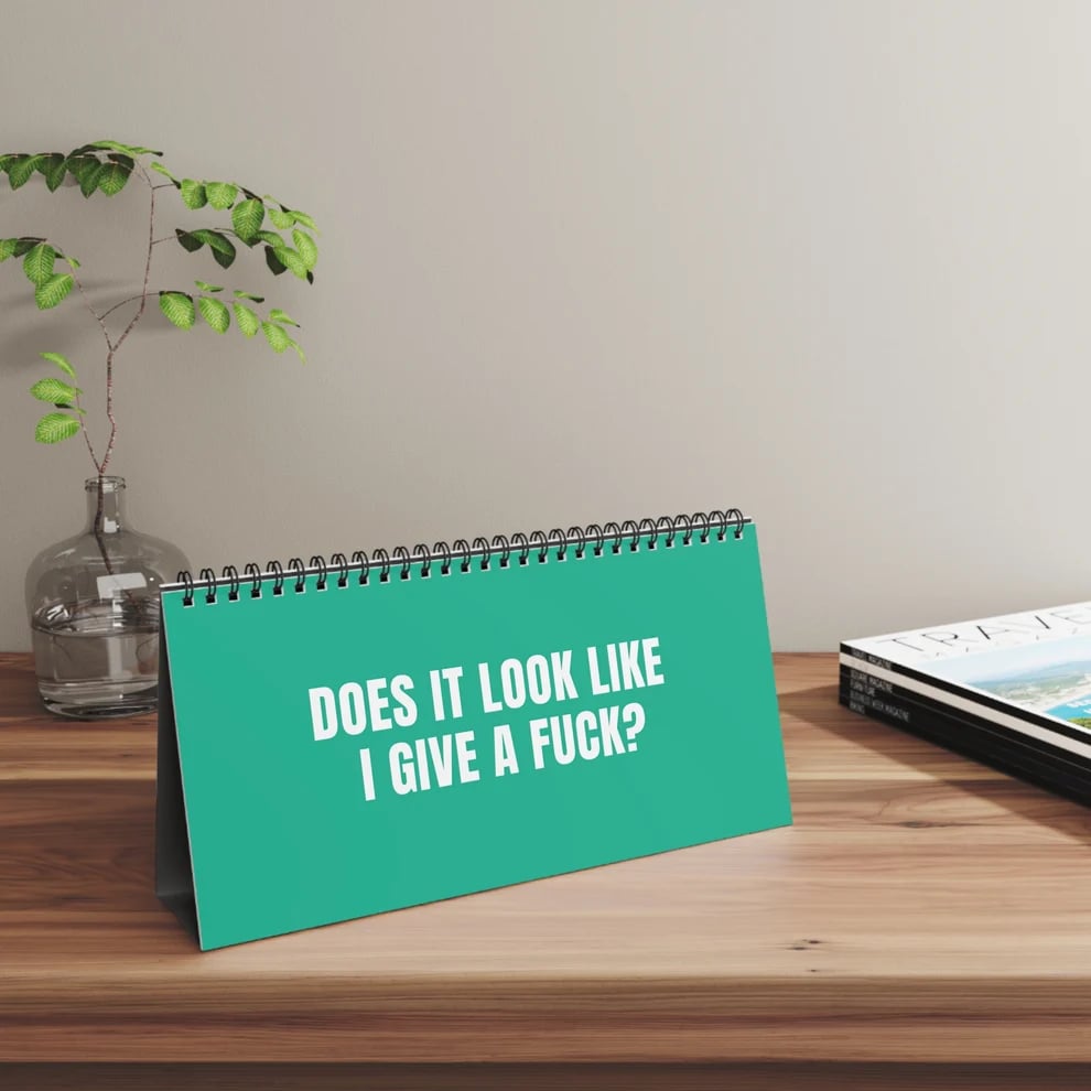 Sarcastic turquoise desk flip sign displayed on a wooden desktop